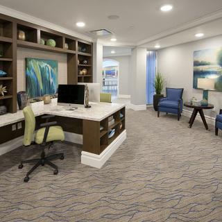A modern office space featuring a desk, seating area, and stylish decor.