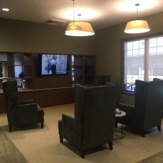 A cozy indoor lounge featuring comfortable seating and a TV for entertainment.