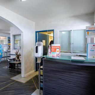 A modern office reception area with a desk and waiting area.