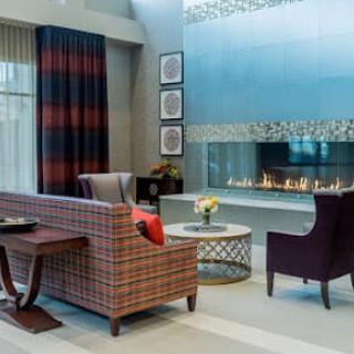 A modern living room featuring a stylish fireplace, comfortable seating, and elegant decor.