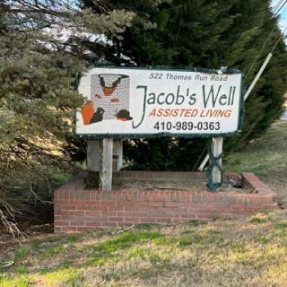 Sign for Jacob's Well Assisted Living located on a roadside.