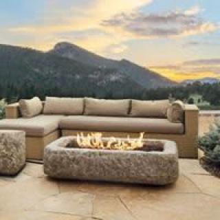 Cozy outdoor patio with a fire pit and mountain views at sunset.