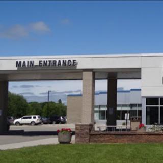 Main entrance of a modern building on a clear day.