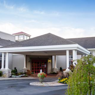 The welcoming entrance of a hotel, featuring well-maintained landscaping and elegant architecture.