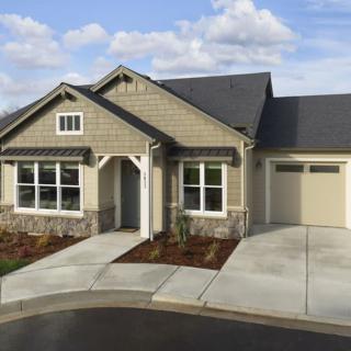 A single-story suburban house with a driveway and garage.
