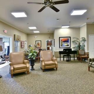 A spacious lobby area with comfortable seating, a piano, and decorative elements.