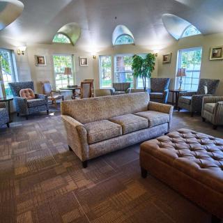 A spacious living room with comfortable seating and natural lighting.