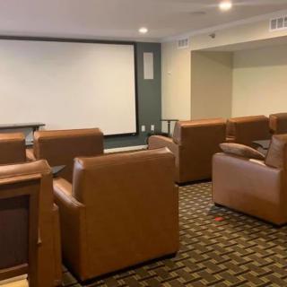 A cozy home theater with comfortable seating and a large screen for viewing.