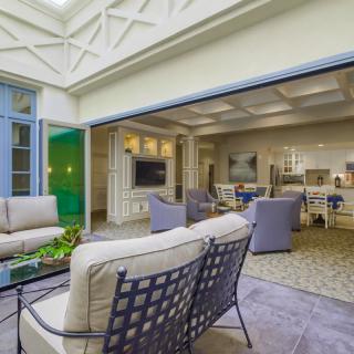 A spacious indoor-outdoor living area with comfortable seating and abundant natural light.