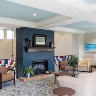 A modern living room featuring a stylish fireplace, comfortable seating, and decorative elements.