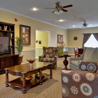 A cozy living room featuring comfortable seating, a television, and elegant decor.