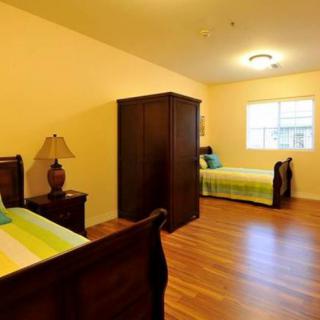 A cozy bedroom with twin wooden beds and a wardrobe.