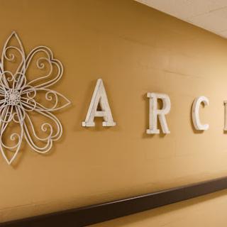 A beautifully designed wall featuring the word 'ARC' and decorative elements.