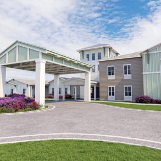 A modern building with a covered entrance and well-maintained landscaping.