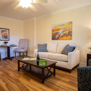 A cozy living room with a comfortable sofa, stylish coffee table, and vibrant artwork on the wall.