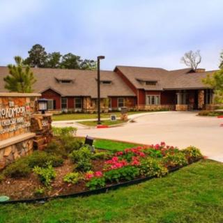 A well-maintained building with a landscaped entrance and flower beds.