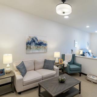 A modern living room featuring a comfortable sofa, an armchair, and stylish decor.