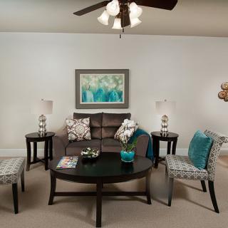 A modern living room with a stylish sofa, coffee table, and decorative accents.