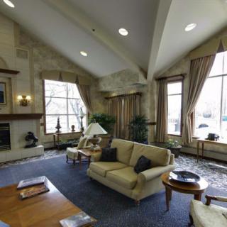 A cozy living room with comfortable sofas and large windows letting in natural light.