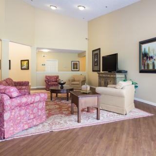 A cozy living room with comfortable furniture and a television.