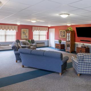 A spacious living room with comfortable seating and a large television.