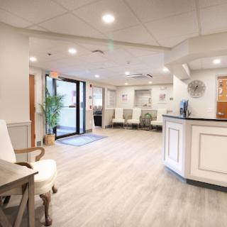 A welcoming reception area of a healthcare facility, featuring modern design elements and a bright, airy atmosphere.