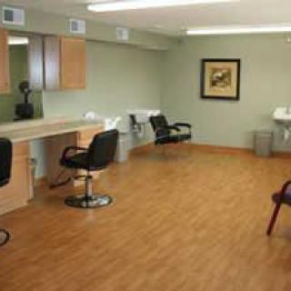 A modern hair salon interior with styling stations and chairs.