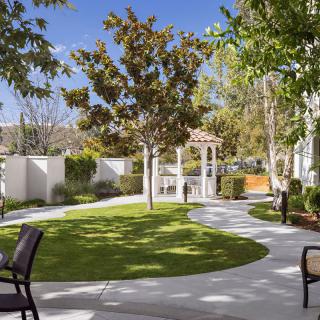 A beautifully landscaped garden with a gazebo and winding pathway.