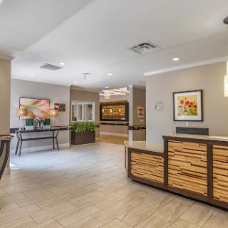 A modern and welcoming lobby area featuring a reception desk, contemporary decor, and comfortable seating.