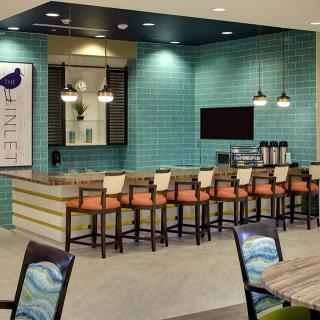 A modern bar and seating area with stylish decor and lighting.