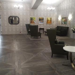 A spacious and modern lobby featuring comfortable seating and artwork on the walls.