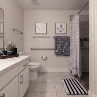 A modern, clean bathroom featuring white tiles and minimalistic decor.