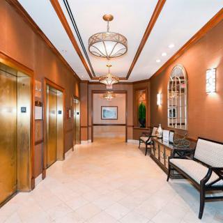 A stylish elevator lobby with warm lighting and elegant interior design features.