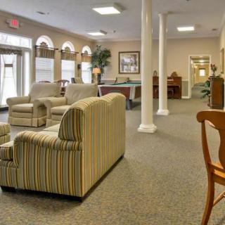 A spacious and neatly arranged lobby with comfortable seating and natural lighting.