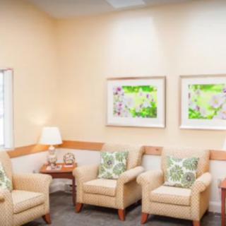 A cozy waiting room with comfortable chairs and decorative artwork.