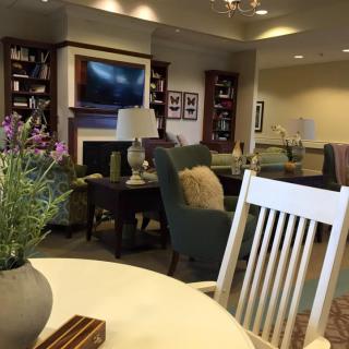 A cozy living room with comfortable seating, a television, and decorative elements.