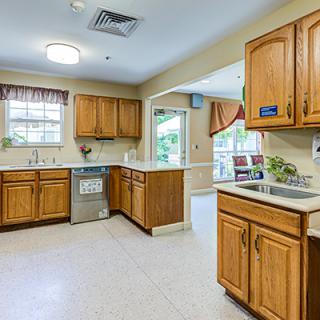 A spacious kitchen with wooden cabinets and modern appliances.