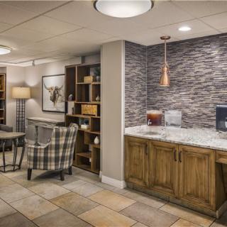 A cozy and modern living room featuring comfortable seating, built-in shelves, and stylish decor elements.