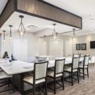 A modern dining area with a kitchen island and stylish lighting fixtures.