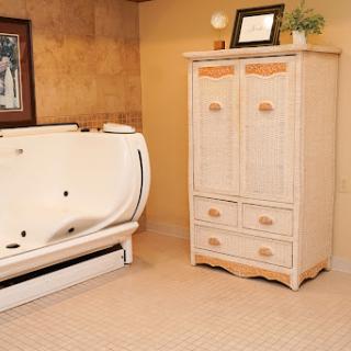 A serene bathroom featuring a modern bathtub and a stylish storage cabinet.