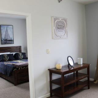 A cozy bedroom with nautical-themed decor and simple furnishings.