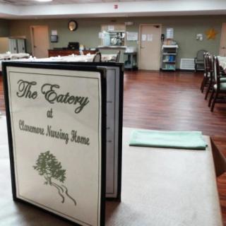 A menu displayed on a table in a dining room setting.
