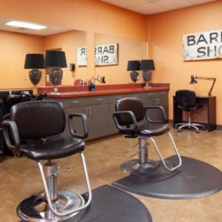 A well-maintained barber shop interior with stylish chairs and decor.