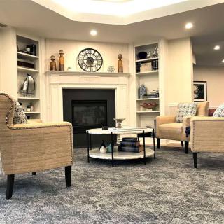 A cozy living room featuring a fireplace, comfortable seating, and elegant decor.