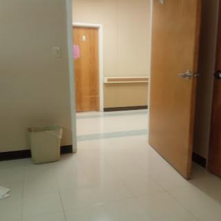 A view of a hallway with doors leading to different rooms.