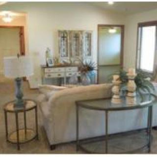 A cozy living room with a sofa, side tables, and decorative items.
