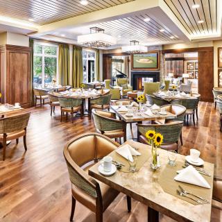 Elegantly designed restaurant interior with neatly arranged dining tables and chairs.