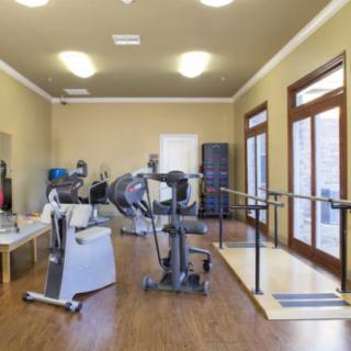 An indoor exercise facility with various fitness and rehabilitation equipment.