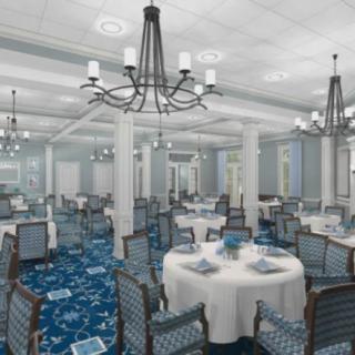 An elegant dining room setup with round tables, chairs, and chandeliers.