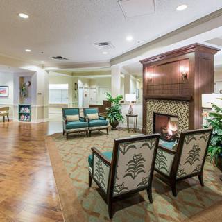 A cozy interior seating area with a fireplace and comfortable chairs.